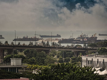 High angle view of buildings against cloudy sky