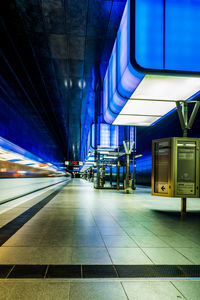 Train at railroad station platform at night