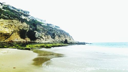 View of calm beach against clear sky