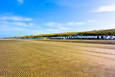 Scenic view of beach against blue sky