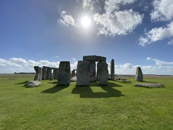 Stone circle on field against sky