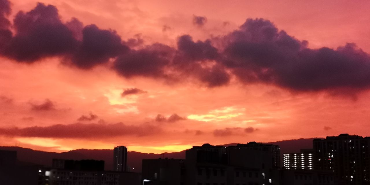 SILHOUETTE BUILDINGS AGAINST DRAMATIC SKY