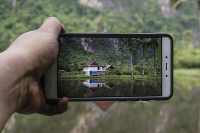 Close-up of man holding vehicle on road