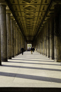 People walking in corridor of building