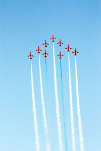 Low angle view of airshow against sky