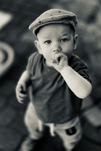 Portrait of a boy one year old wearing a retro country style helmet beret , excitement and dynamism 