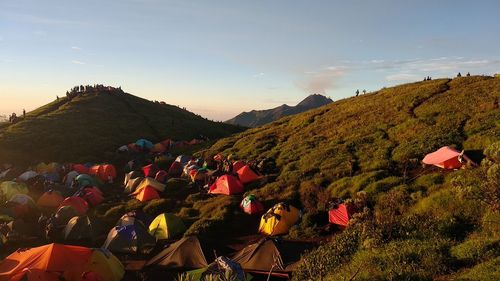 People on mountain against sky