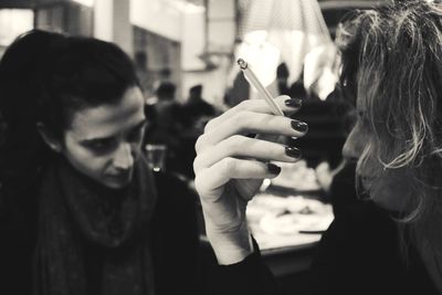 Close-up of woman holding camera