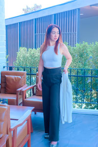 Portrait of young woman standing outdoors