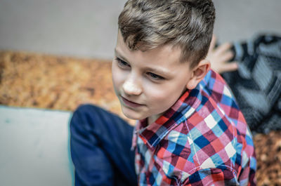 High angle view of boy sitting on floor at home