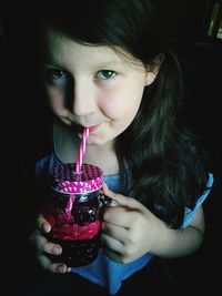 Portrait of girl drinking from jar
