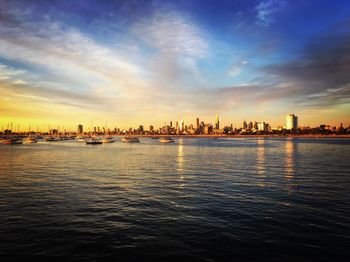 City at waterfront during sunset