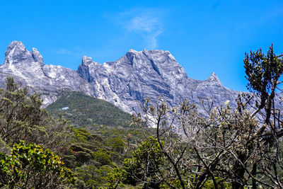 Scenic view of mountains against clear blue sky