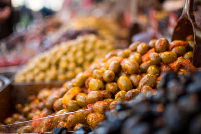 Close-up of spiced olives for sale at market stall