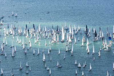 High angle view of sailboats in sea against building