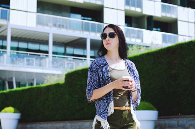 Young happy business woman relaxing in city, outdoor cafe. drinking coffee. using phone. summer