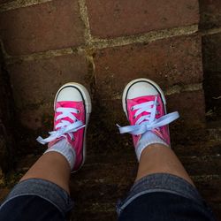 Low section of woman standing on tiled floor