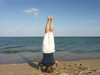 Full length of woman on beach against sky