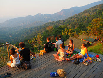 Group of people sitting on mountain road