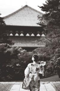 Woman with flowers in background