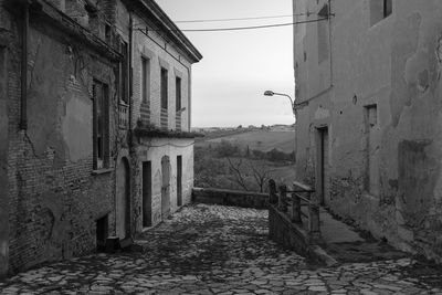 Narrow alley amidst buildings in city