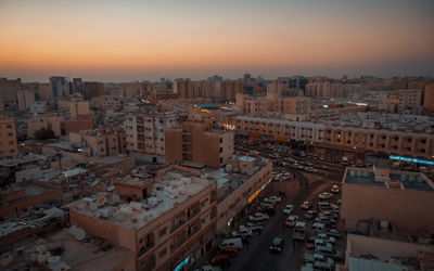 High angle view of buildings in city against sky during sunset