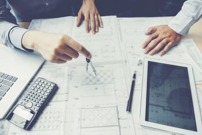High angle view of people working on table