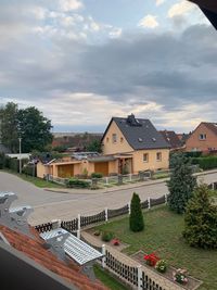 High angle view of houses and buildings against sky