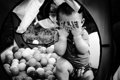 Playing in a ball pit at his birthday party.