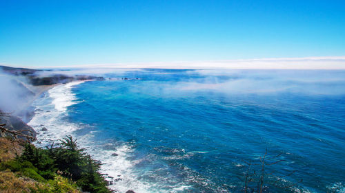 Scenic view of sea against clear blue sky