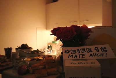 Woman with flowers on table at home