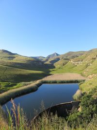 Scenic view of lake against clear blue sky