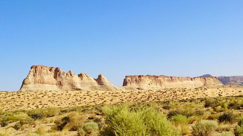 Low angle view of rock formations against blue sky