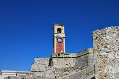 Low angle view of historic building against blue sky