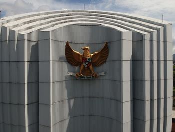 Low angle view of sculpture against building