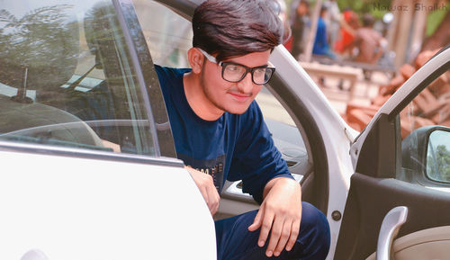 Portrait of man sitting in car