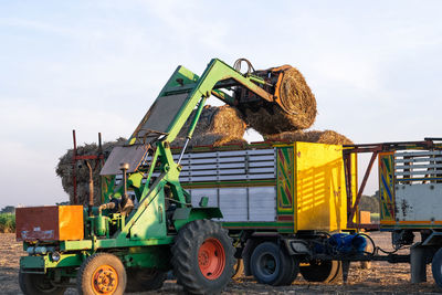 Traditional windmill in farm against sky