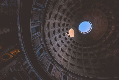 Low angle view of hole in ornate ceiling