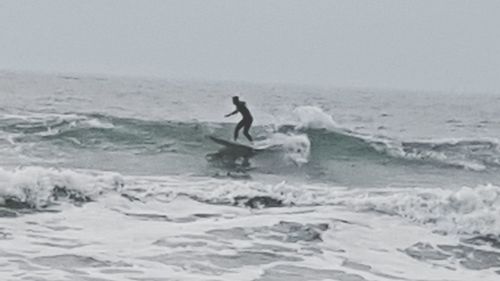 People surfing on beach