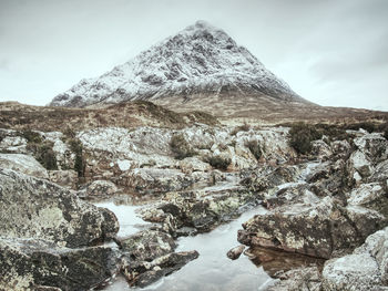 Buachaille etive mor alongside  river coupall near glencoe in scottish winter day.. hipster filter.