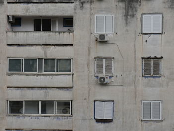 Full frame shot of grey and poor building