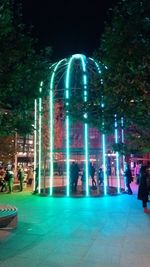 Illuminated fountain against sky at night