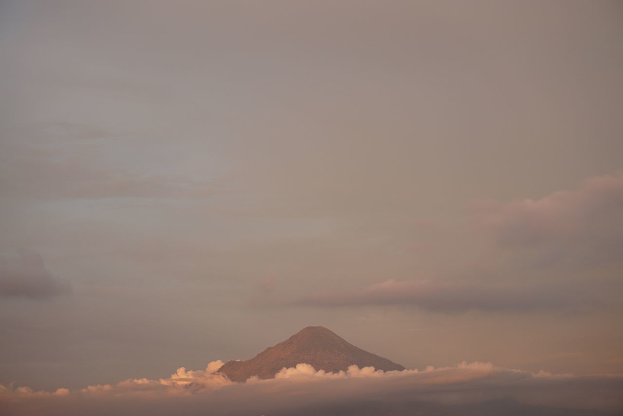 tranquil scene, scenics, tranquility, beauty in nature, sky, mountain, nature, cloud - sky, sunset, idyllic, weather, majestic, mountain range, non-urban scene, orange color, outdoors, low angle view, no people, cloud, snow