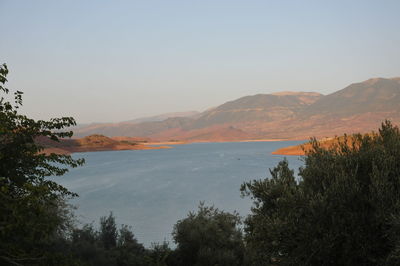 Scenic view of lake and mountains against clear sky