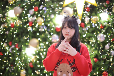 Young woman holding christmas tree