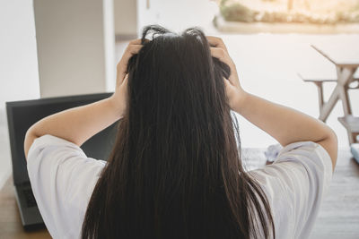 Rear view of woman at home