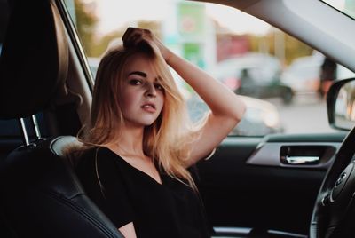 Portrait of young woman in car