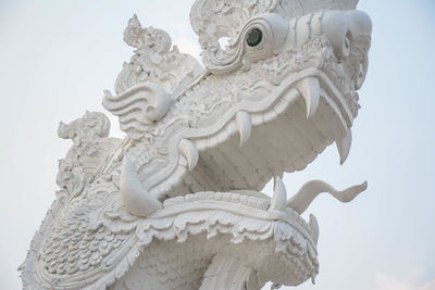Chinese white dragon statues for decoration in separate temples on a white background.