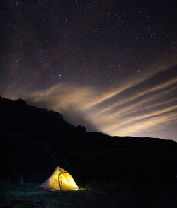 Tent on field against sky at night