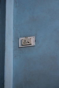 Close-up of information sign on wall